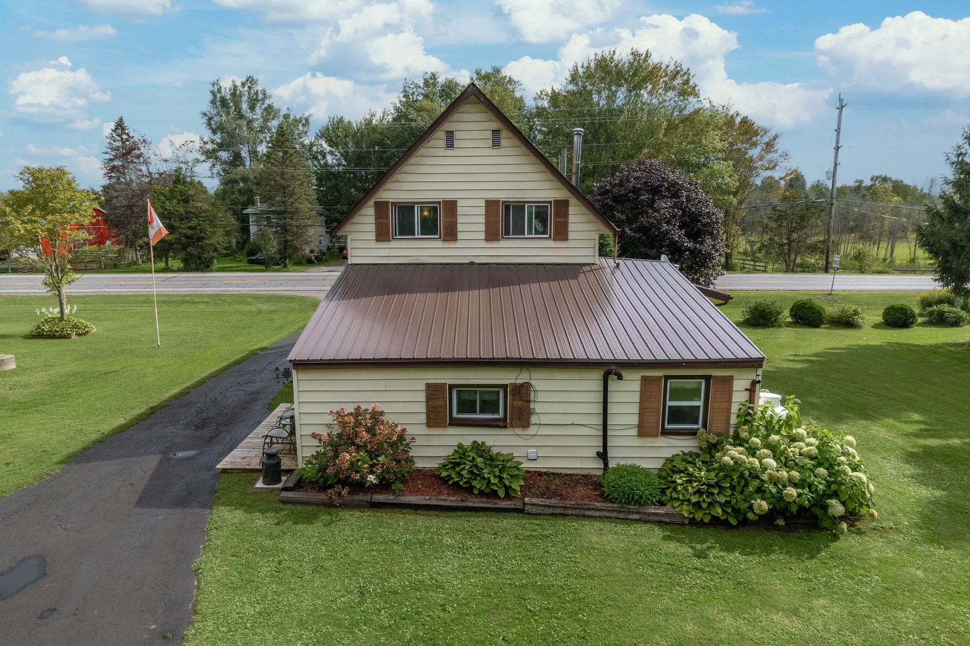 Aerial shot showing farmhouse, outbuildings and 8.3 acres of land