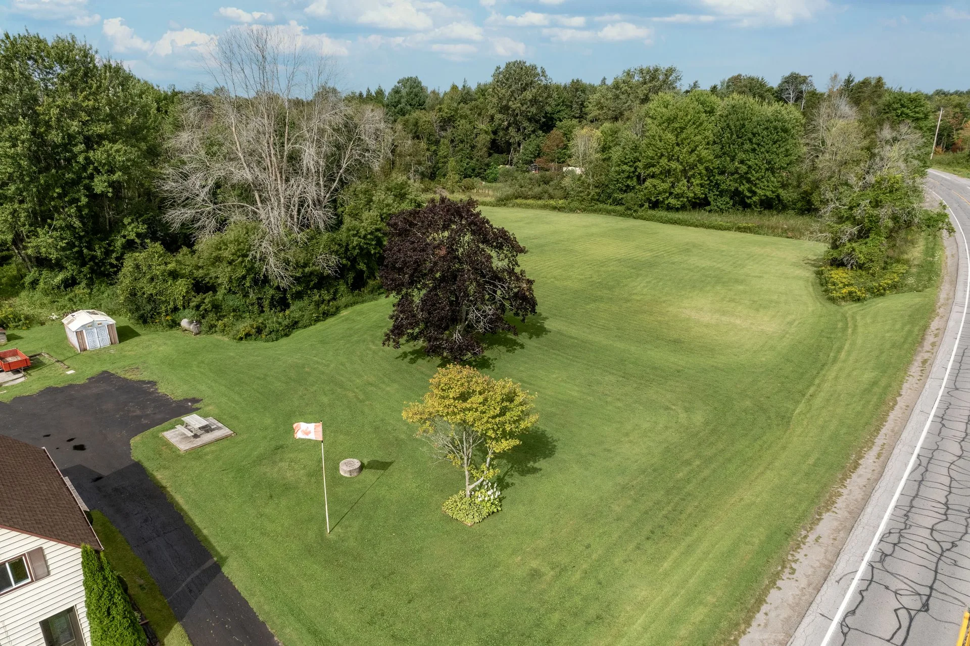 Low drone shot of 21331 Loyalist Pkwy with open sky and farmstead below
