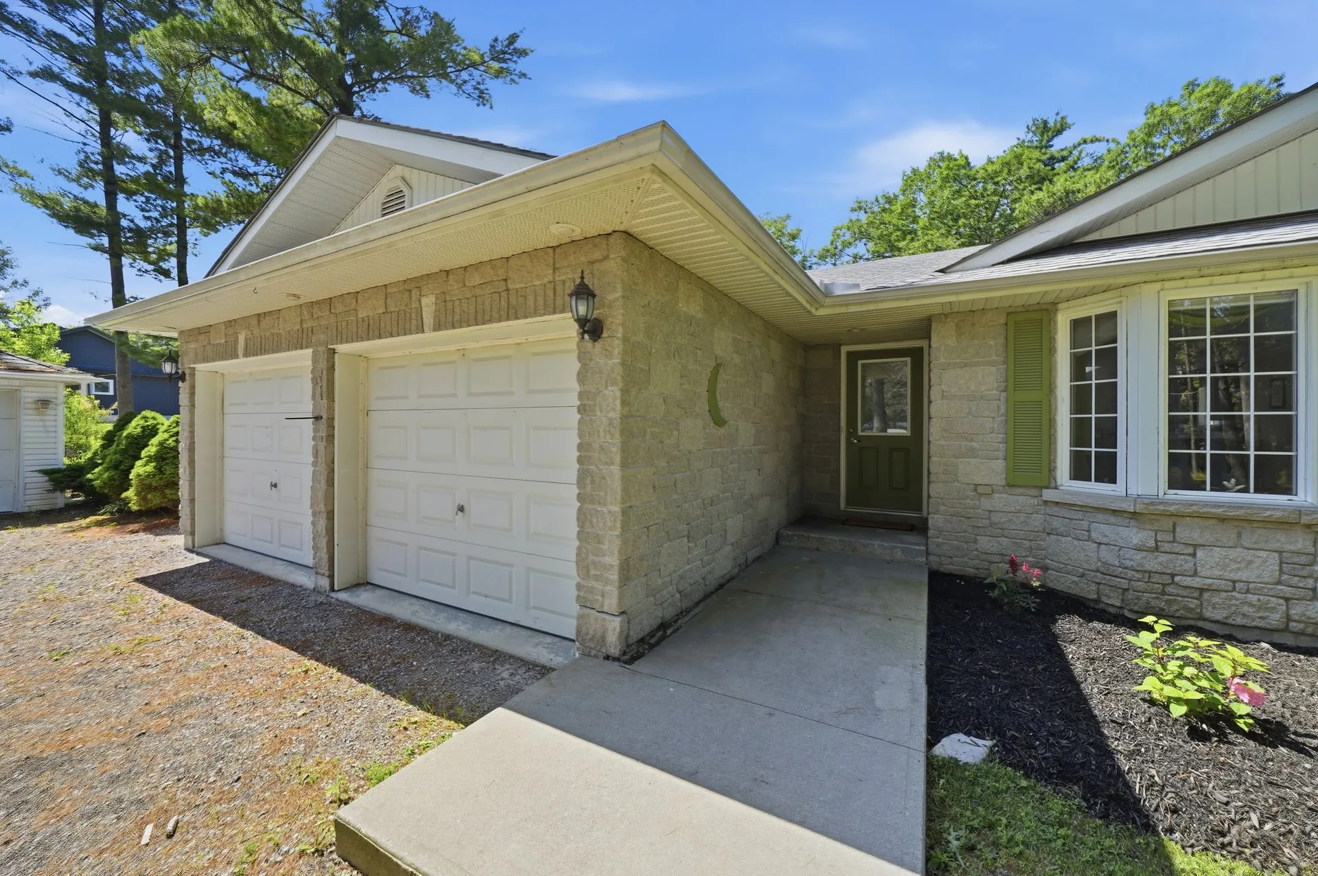 Front elevation and attached two-car garage at 21627 Loyalist Parkway, Carrying Place, PEC