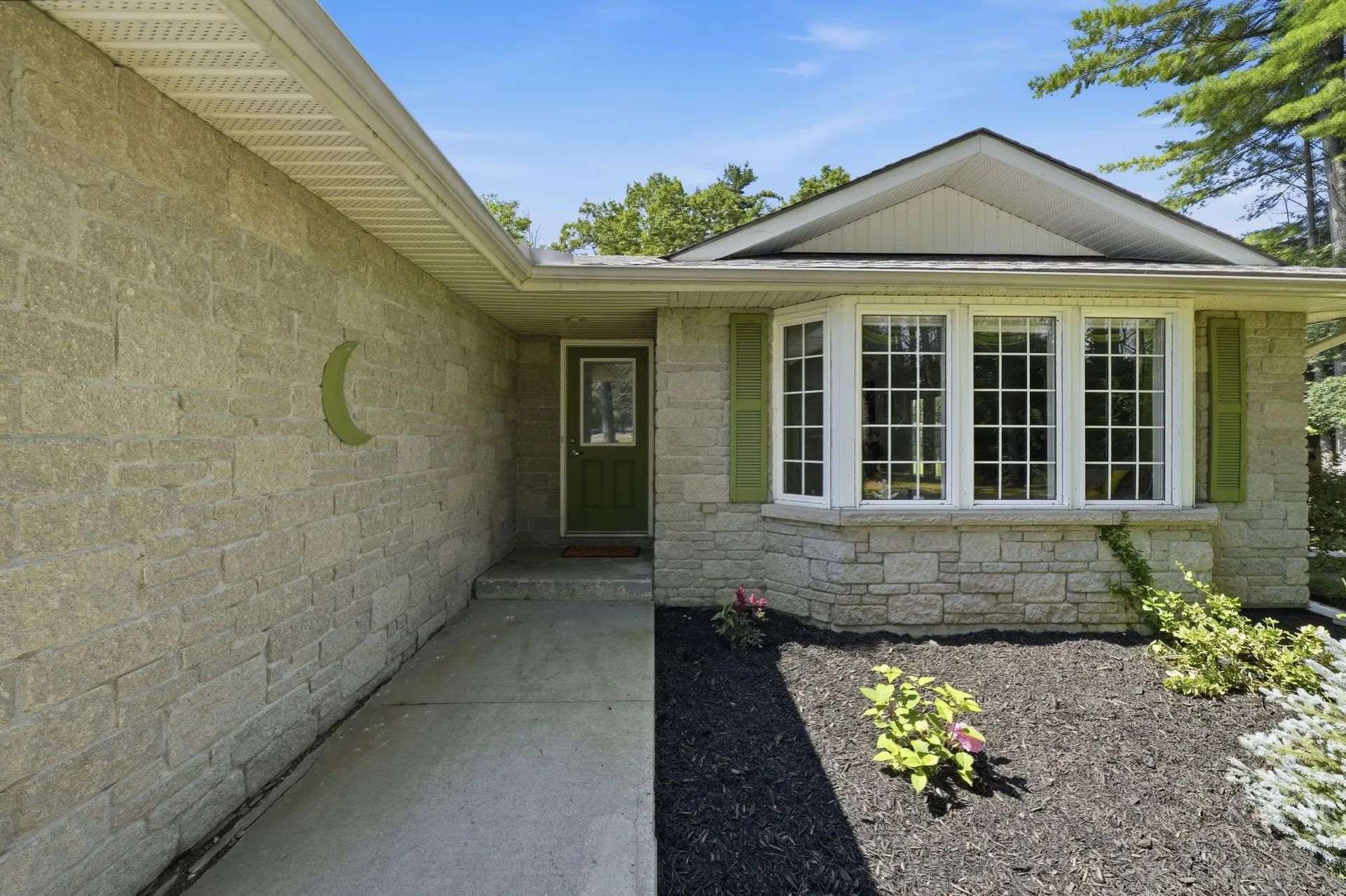 Front entry and bay window with stone exterior at 21627 Loyalist Parkway, Prince Edward County