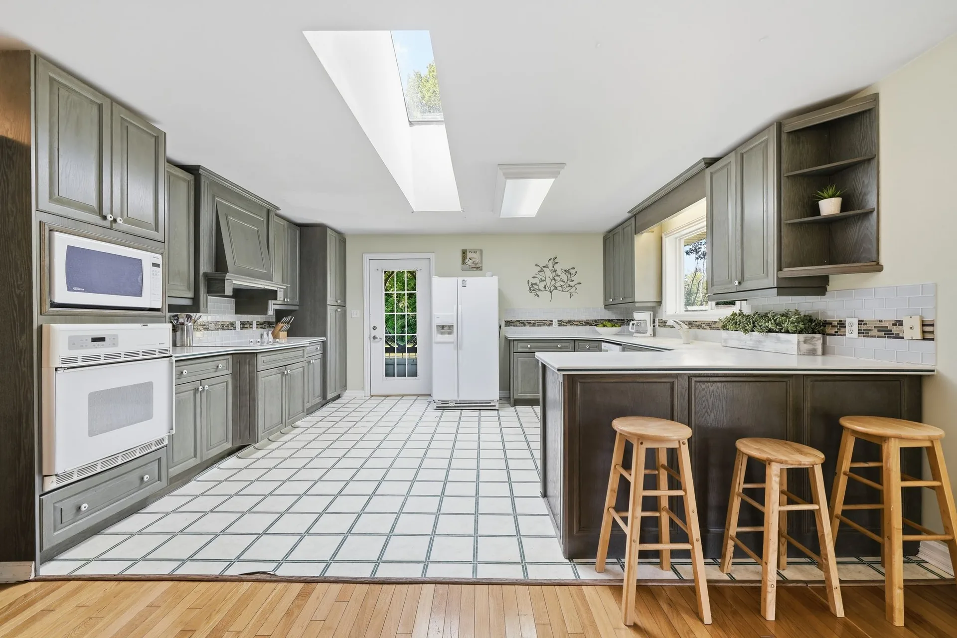 Kitchen with centre island, breakfast bar, and skylights at 21627 Loyalist Parkway, Prince Edward County