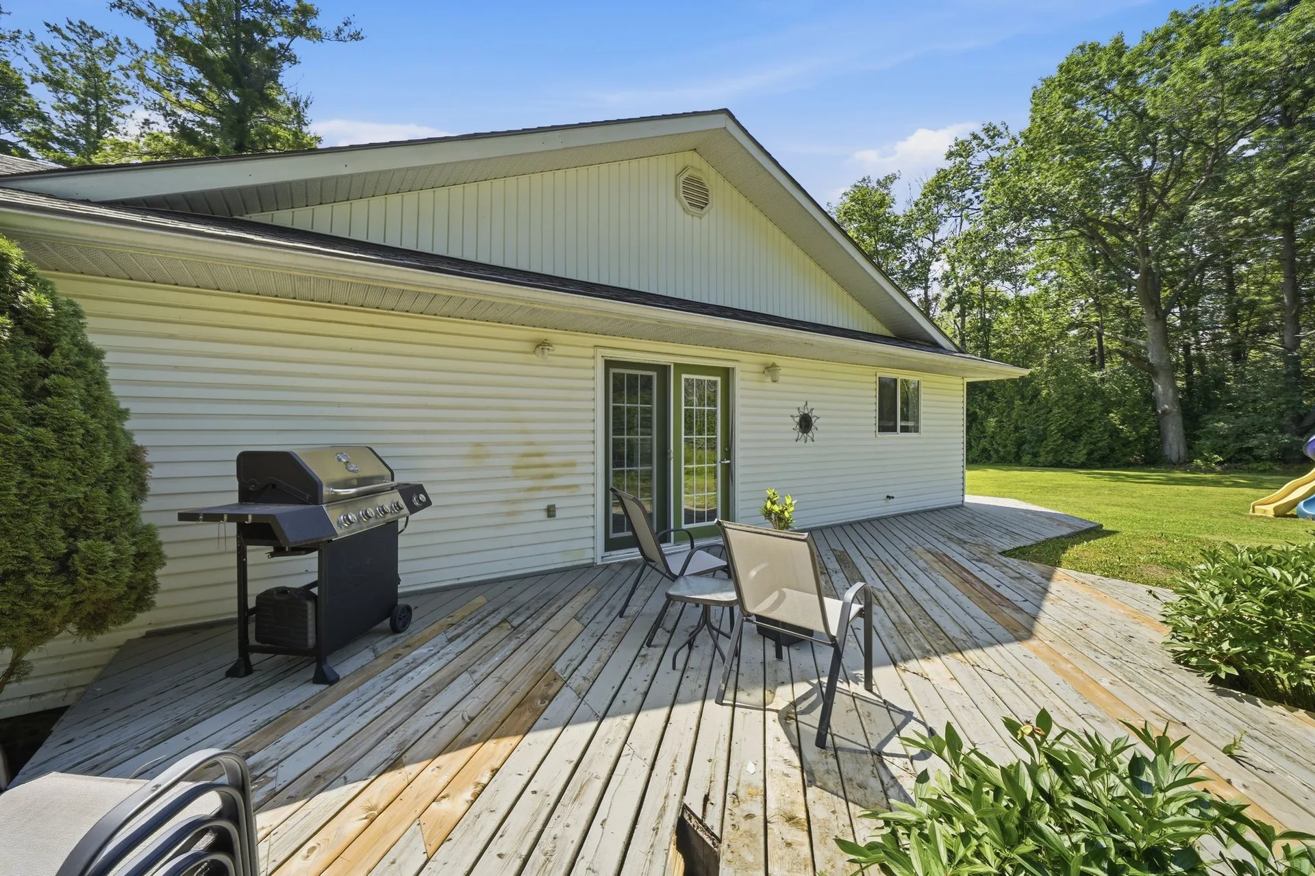 Rear deck with barbecue and backyard at 21627 Loyalist Parkway, Prince Edward County