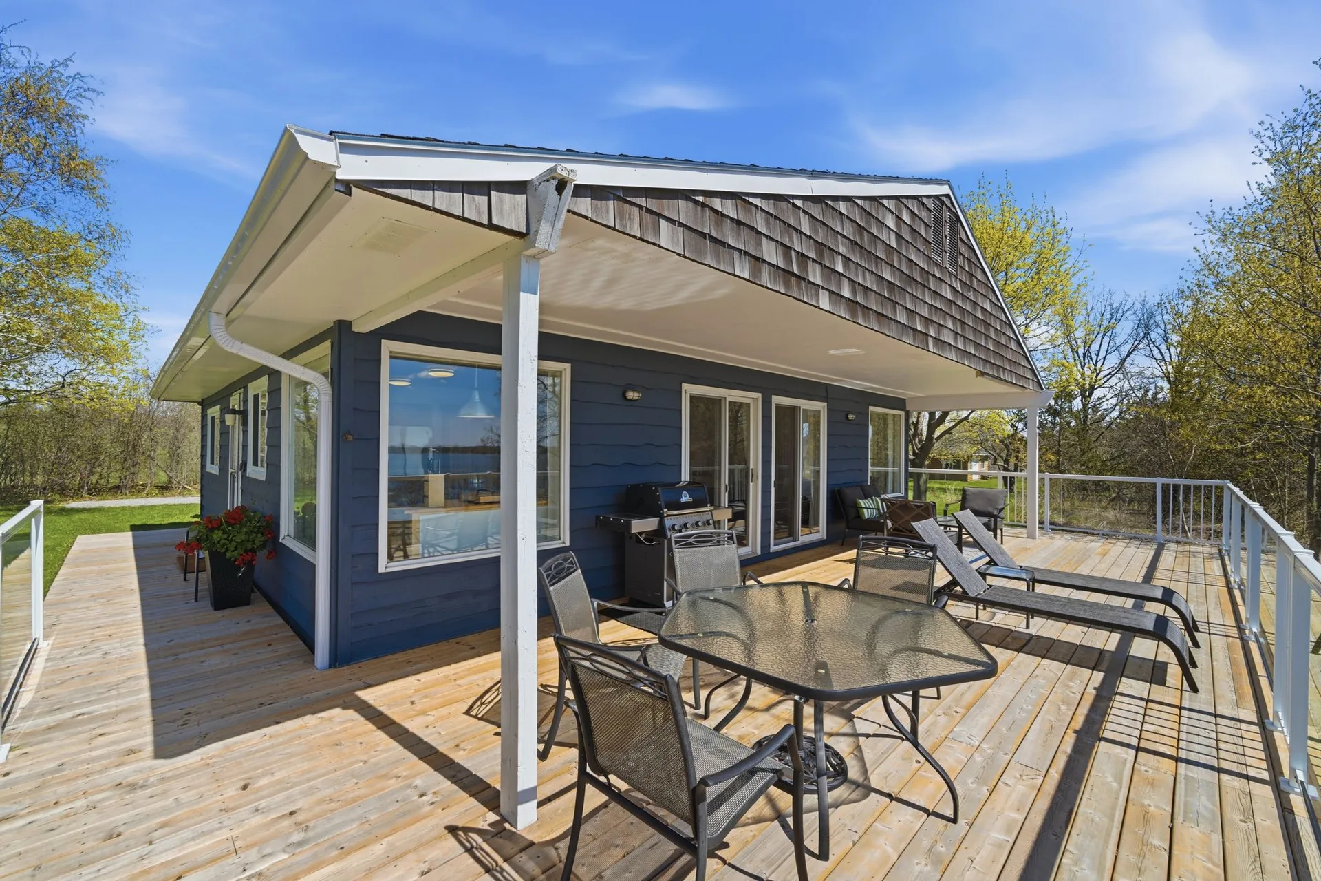 Front view of 86 Colliers Road cottage with covered deck overlooking South Bay, PEC
