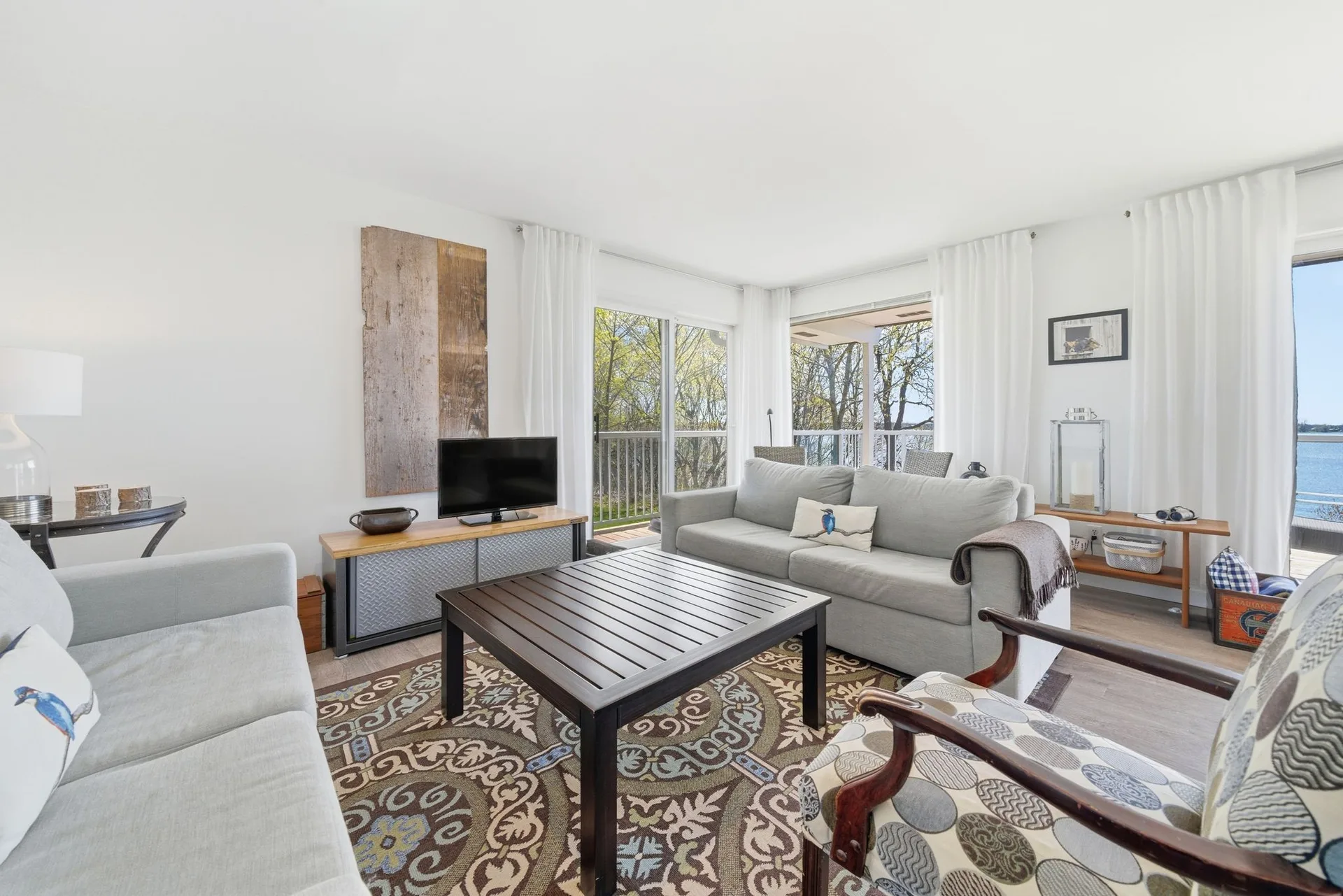 Living room interior with large windows and waterfront views, 86 Colliers Road