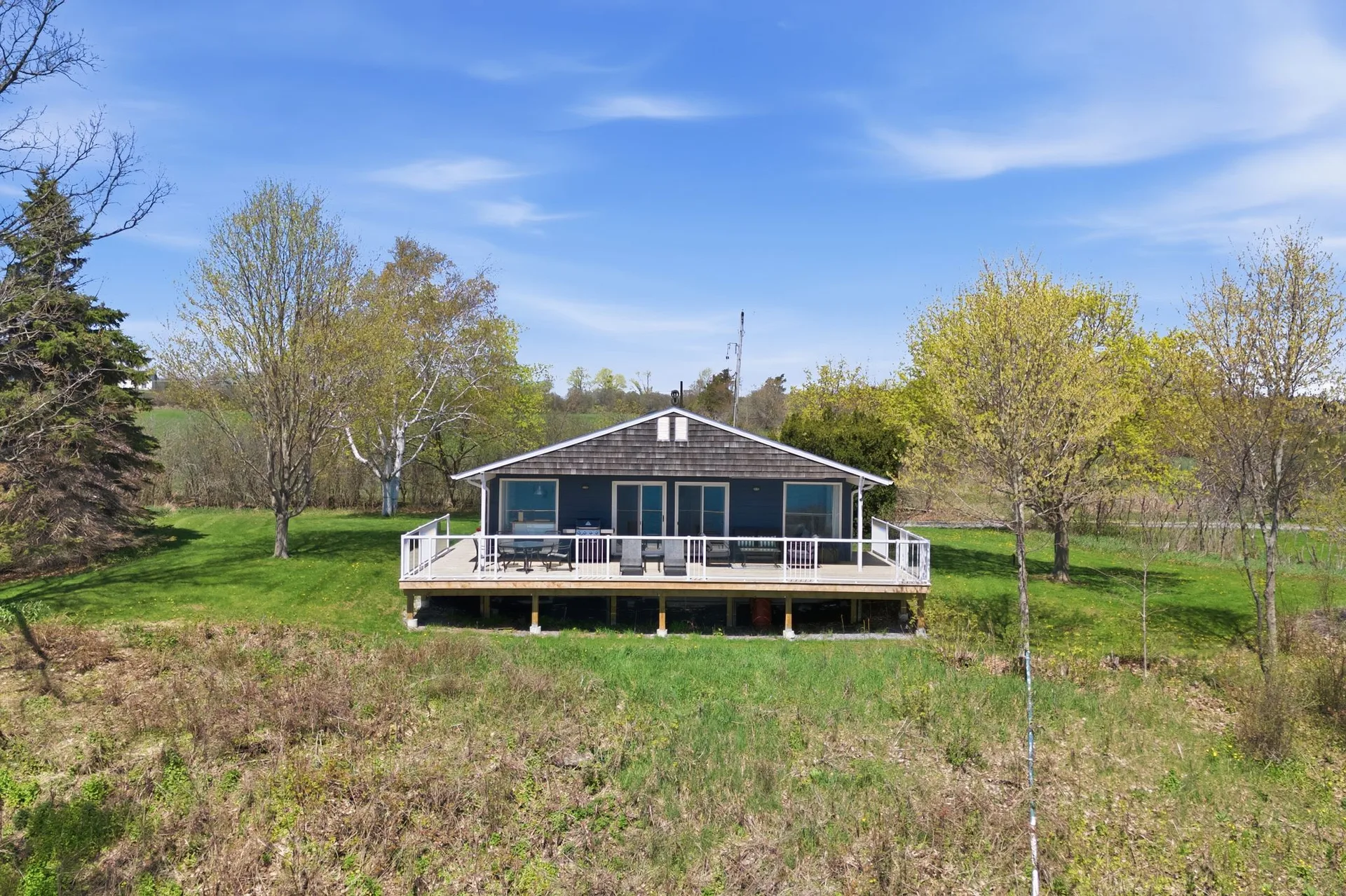 Rear deck and lawn at 86 Colliers Road overlooking South Bay, PEC