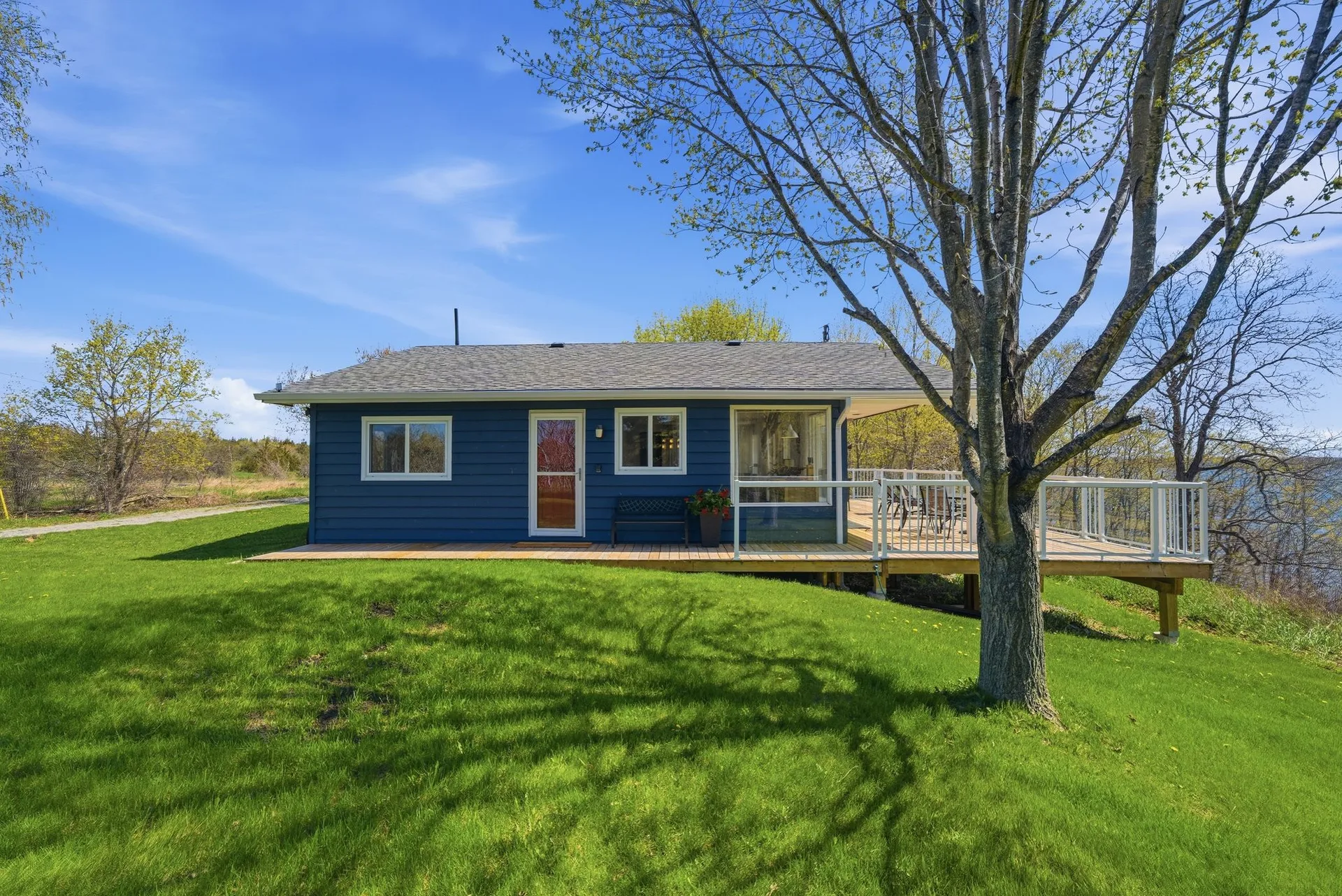 Cottage side elevation with deck and South Bay view, 86 Colliers Road, PEC