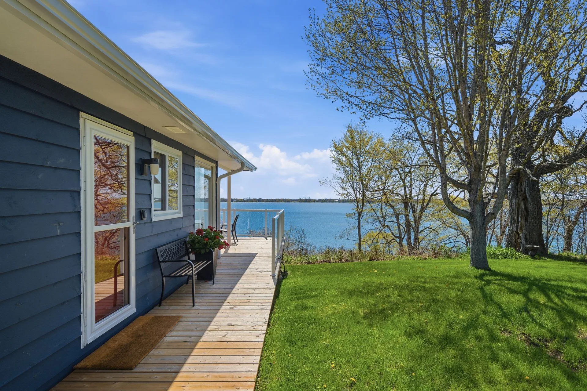 Deck with South Bay views and cottage exterior, 86 Colliers Road, Prince Edward County