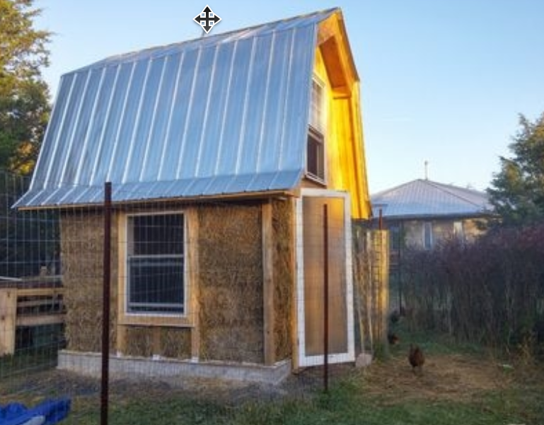 Straw bales being lifted and placed into the wall courses