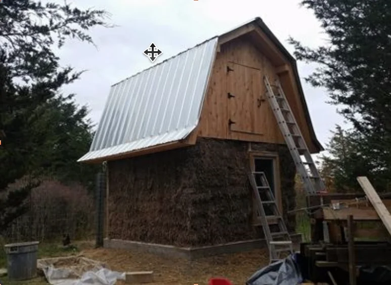 Straw bale walls fully raised on the chicken coop, the building is sealed in