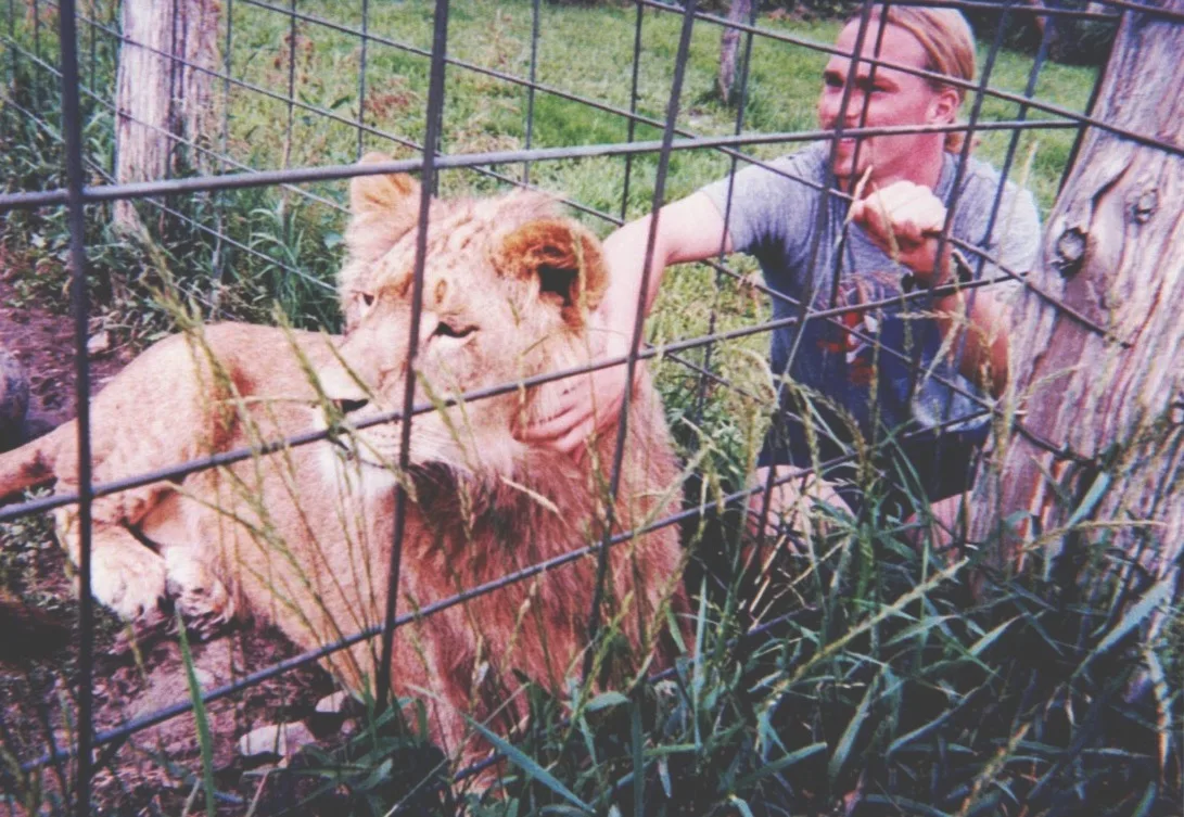 A young Jake Bergeron with Zamba the lion at his family's animal sanctuary in Prince Edward County