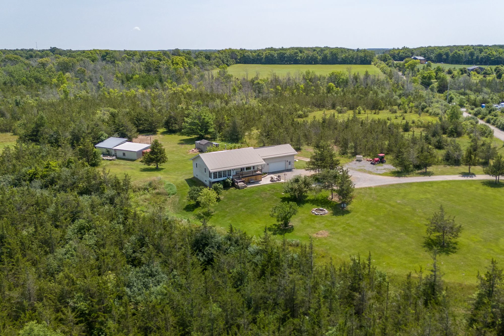 Aerial view of a bungalow on acreage in Prince Edward County, Ontario