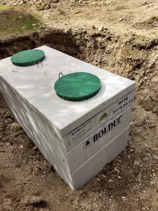 Newly installed concrete septic tank with green lids in Prince Edward County