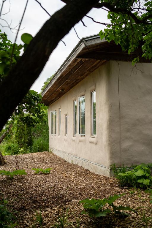 Side exterior wall of Jake's straw bale home — lime plaster finish